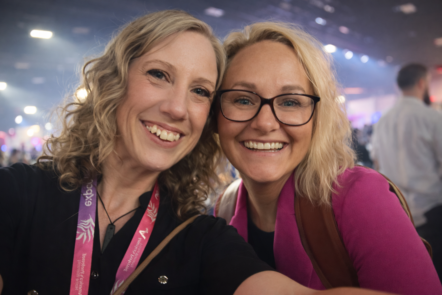 Two women smiling together at an event