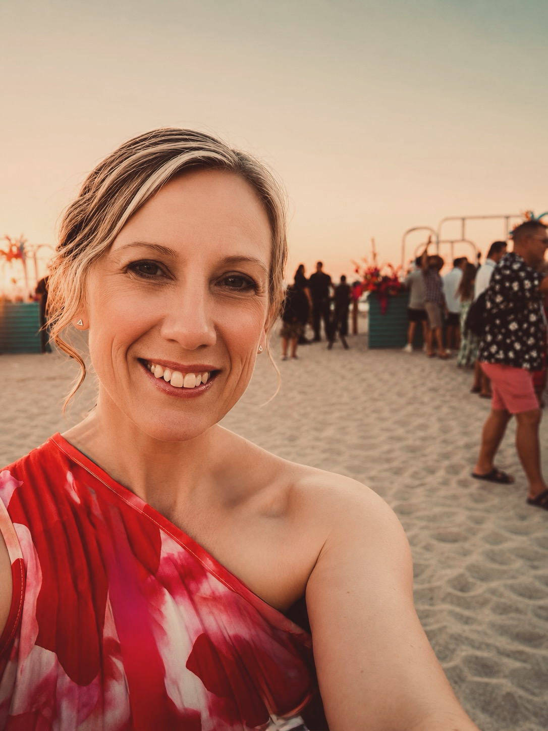Jasmine Rohland smiling at an outdoor gathering at sunset